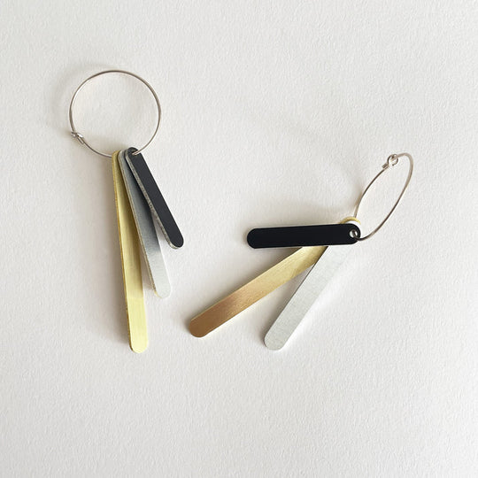 Capsule drop earrings by Tom Pigeon